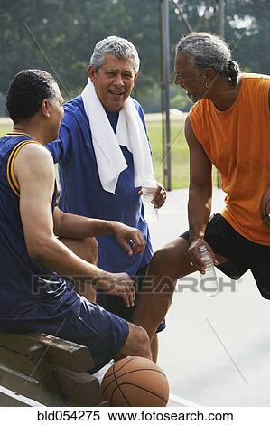 Multi-ethnic men talking on basketball court View Large Photo Image Stock Photography - Multi-ethnic men talking on basketball court. Fotosearch