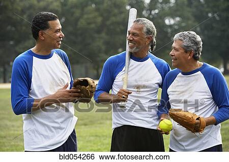 Stock Photograph - Multi-ethnic men with baseball gear. Fotosearch