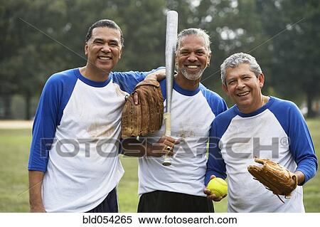 Stock Photography - Multi-ethnic men with baseball gear. Fotosearch
