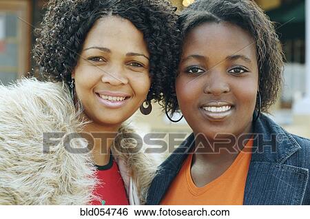 Stock Photograph - Multi-ethnic women hugging. Fotosearch