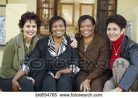Multi-ethnic women sitting on porch steps View Large Photo Image Stock Photography - Multi-ethnic women sitting on porch steps. Fotosearch