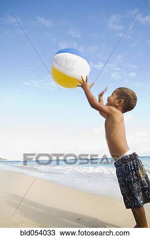 Pacific Islander boy playing with beach ball View Large Photo Image Stock Image - Pacific Islander boy playing with beach ball. Fotosearch