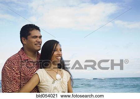Stock Image - Pacific Islander couple at beach. Fotosearch