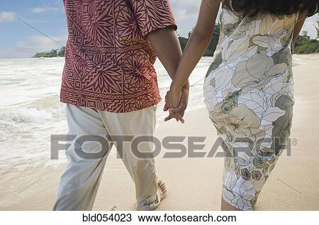 Pacific Islander couple walking on beach View Large Photo Image Stock Image - Pacific Islander couple walking on beach. Fotosearch