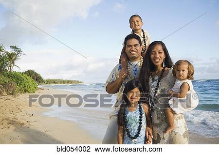 Stock Image - Pacific Islander family at beach. Fotosearch