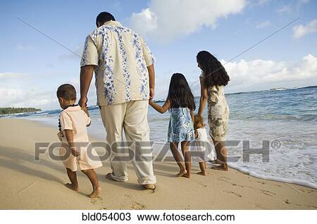 Pacific Islander family walking on beach View Large Photo Image Stock Image - Pacific Islander family walking on beach. Fotosearch
