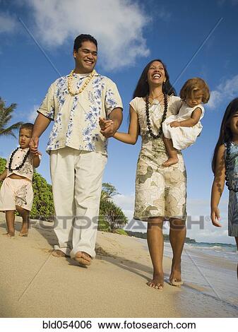 Pacific Islander family walking on beach View Large Photo Image Stock Photograph - Pacific Islander family walking on beach. Fotosearch