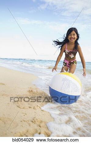 Pacific Islander girl playing with beach ball View Large Photo Image Stock Photo - Pacific Islander girl playing with beach ball. Fotosearch