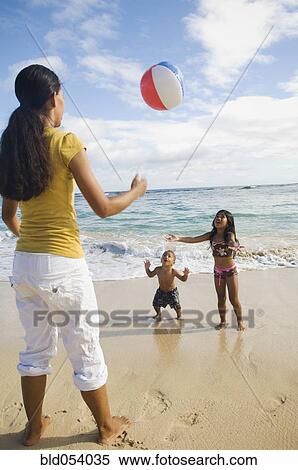 Pacific Islander mother and children playing with beach ball View Large Photo Image Stock Photography - Pacific Islander mother and children playing with beach ball. Fotosearch
