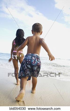 Pacific Islander siblings running on beach View Large Photo Image Stock Image - Pacific Islander siblings running on beach. Fotosearch