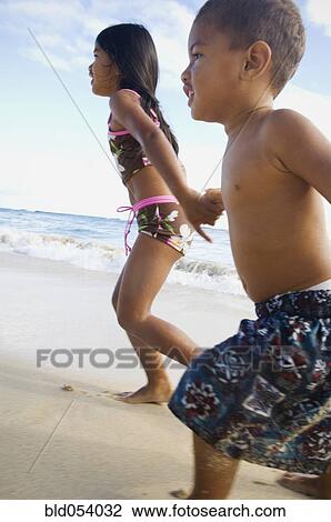 Pacific Islander siblings running on beach View Large Photo Image Stock Image - Pacific Islander siblings running on beach. Fotosearch