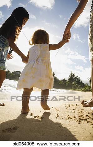 Stock Photo - Pacific Islander toddler walking on beach. Fotosearch