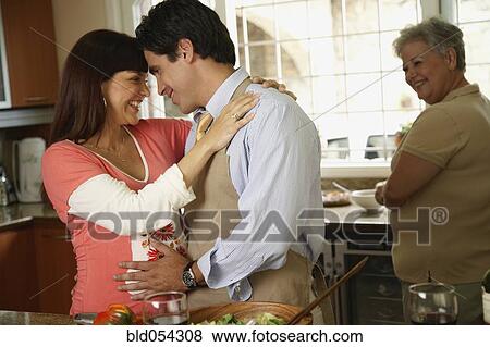 Pregnant Hispanic couple hugging View Large Photo Image Stock Photo - Pregnant Hispanic couple hugging. Fotosearch