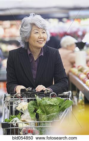Senior Asian woman in grocery store View Large Photo Image Stock Image - Senior Asian woman in grocery store. Fotosearch