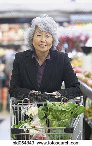 Senior Asian woman in grocery store View Large Photo Image Stock Photo - Senior Asian woman in grocery store. Fotosearch