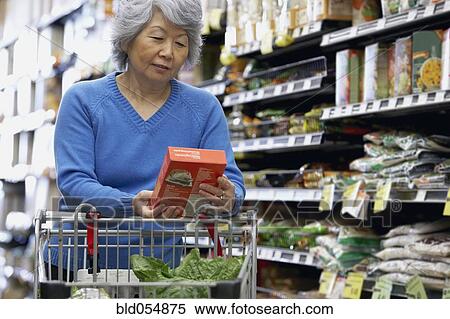 Senior Asian woman reading label at grocery store View Large Photo Image Stock Photography - Senior Asian woman reading label at grocery store. Fotosearch