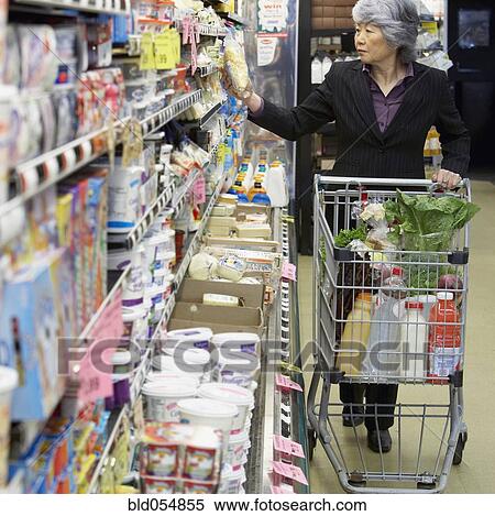 Senior Asian woman shopping in grocery store View Large Photo Image Stock Photography - Senior Asian woman shopping in grocery store. Fotosearch