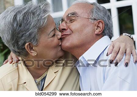 Stock Photo - Senior Hispanic couple kissing. Fotosearch