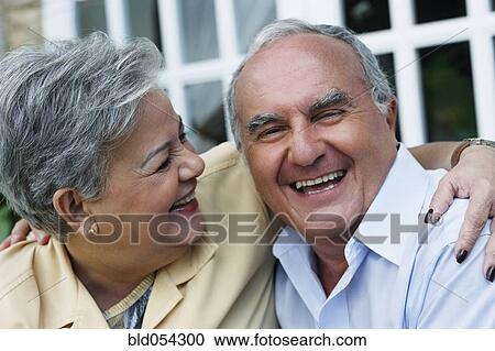 Stock Photography - Senior Hispanic couple laughing. Fotosearch - Search Stock Photos, Pictures, Wall Murals, Images, and Photo Clipart