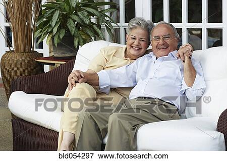 Senior Hispanic couple sitting on sofa View Large Photo Image Picture - Senior Hispanic couple sitting on sofa. Fotosearch - Search Stock Photography, Photos, Prints, Images, and Photo Clipart
