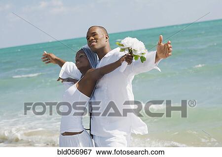 African bride and groom at beach View Large Photo Image Stock Photo - African bride and groom at beach. Fotosearch