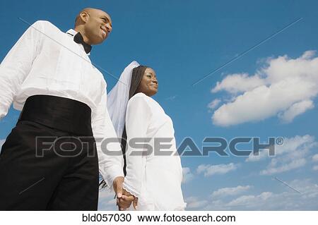 African bride and groom holding hands View Large Photo Image Stock Image - African bride and groom holding hands. Fotosearch