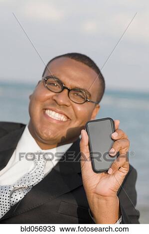 African businessman holding electronic organizer View Large Photo Image Stock Image - African businessman holding electronic organizer. Fotosearch