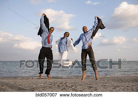 African businesspeople cheering at beach View Large Photo Image Stock Photo - African businesspeople cheering at beach. Fotosearch