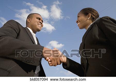 Picture - African businesspeople shaking hands. Fotosearch