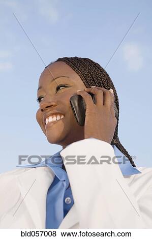 African businesswoman talking on cell phone View Large Photo Image Stock Photo - African businesswoman talking on cell phone. Fotosearch