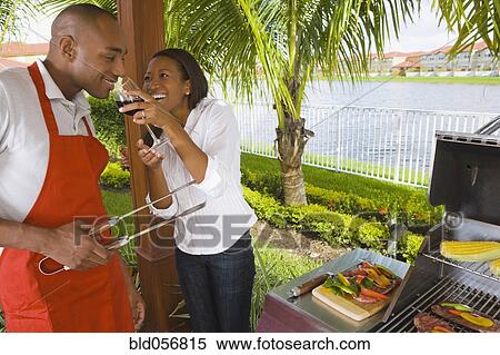 Stock Photography - African couple barbecuing. Fotosearch