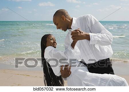 African couple dancing at beach View Large Photo Image Stock Image - African couple dancing at beach. Fotosearch