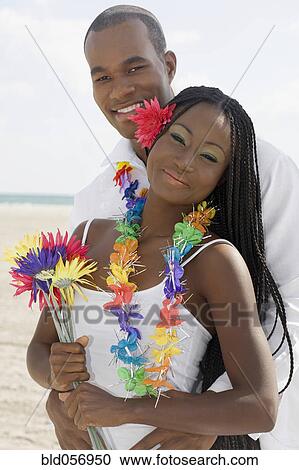 African couple hugging at beach View Large Photo Image Stock Image - African couple hugging at beach. Fotosearch