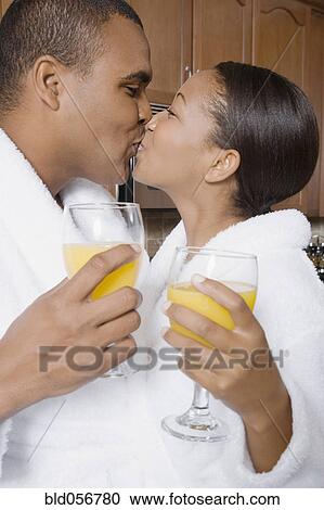 Stock Image - African couple kissing. Fotosearch