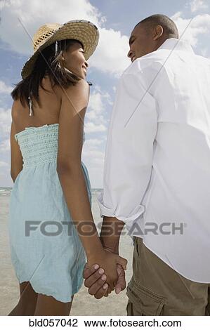 Stock Image - African couple smiling at each other. Fotosearch