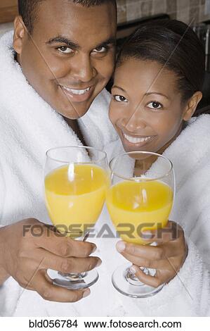 African couple toasting with orange juice View Large Photo Image Picture - African couple toasting with orange juice. Fotosearch