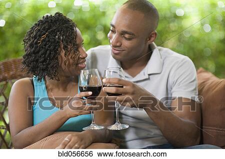 Stock Photograph - African couple toasting with wine. Fotosearch