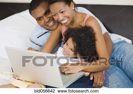 African family looking at laptop View Large Photo Image Stock Image - African family looking at laptop. Fotosearch