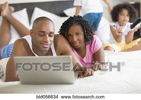African family relaxing on bed View Large Photo Image Picture - African family relaxing on bed. Fotosearch