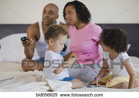 African family watching television and playing View Large Photo Image Stock Photo - African family watching television and playing. Fotosearch