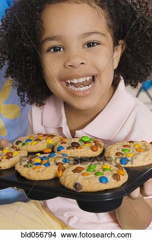 African girl holding cupcakes View Large Photo Image Picture - African girl holding cupcakes. Fotosearch
