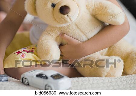 African girl holding teddy bear View Large Photo Image Stock Image - African girl holding teddy bear. Fotosearch