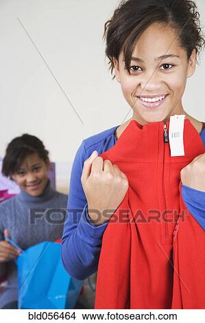 Picture - African girl with twin sister in background. Fotosearch