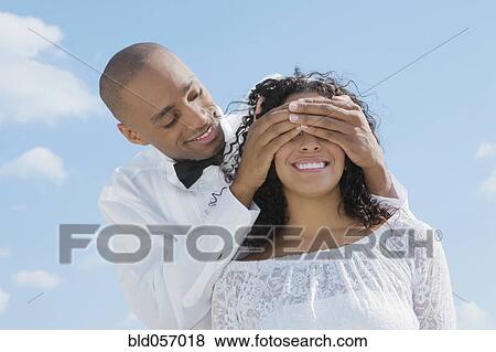African groom covering bride’s eyes View Large Photo Image Stock Photo - African groom covering bride’s eyes. Fotosearch