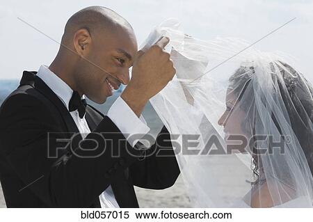 African groom lifting bride’s veil View Large Photo Image Stock Photography - African groom lifting bride’s veil. Fotosearch