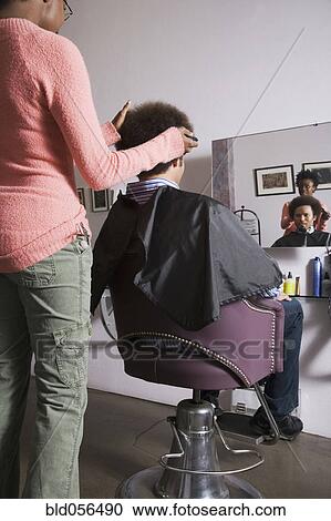 African hair stylist cutting Mixed Race man’s hair View Large Photo Image Stock Image - African hair stylist cutting Mixed Race man’s hair. Fotosearch