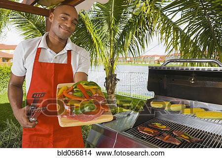 African man barbecuing View Large Photo Image Picture - African man barbecuing. Fotosearch