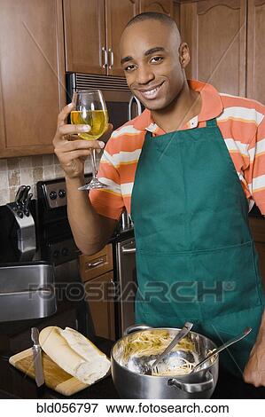 African man cooking and drinking wine View Large Photo Image Stock Photo - African man cooking and drinking wine. Fotosearch