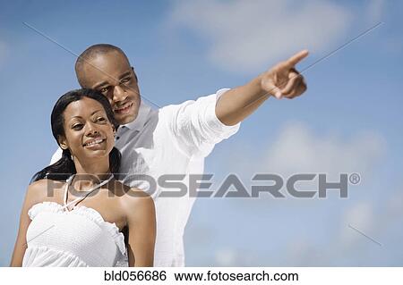 African man pointing for girlfriend View Large Photo Image Stock Photograph - African man pointing for girlfriend. Fotosearch