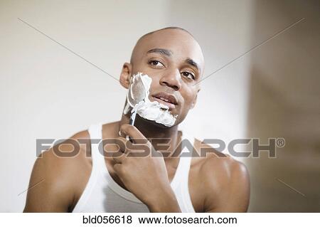 Stock Photo - African man shaving face. Fotosearch